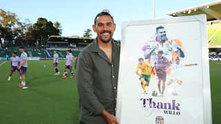 A man holding a thank you sign on a soccer field.
