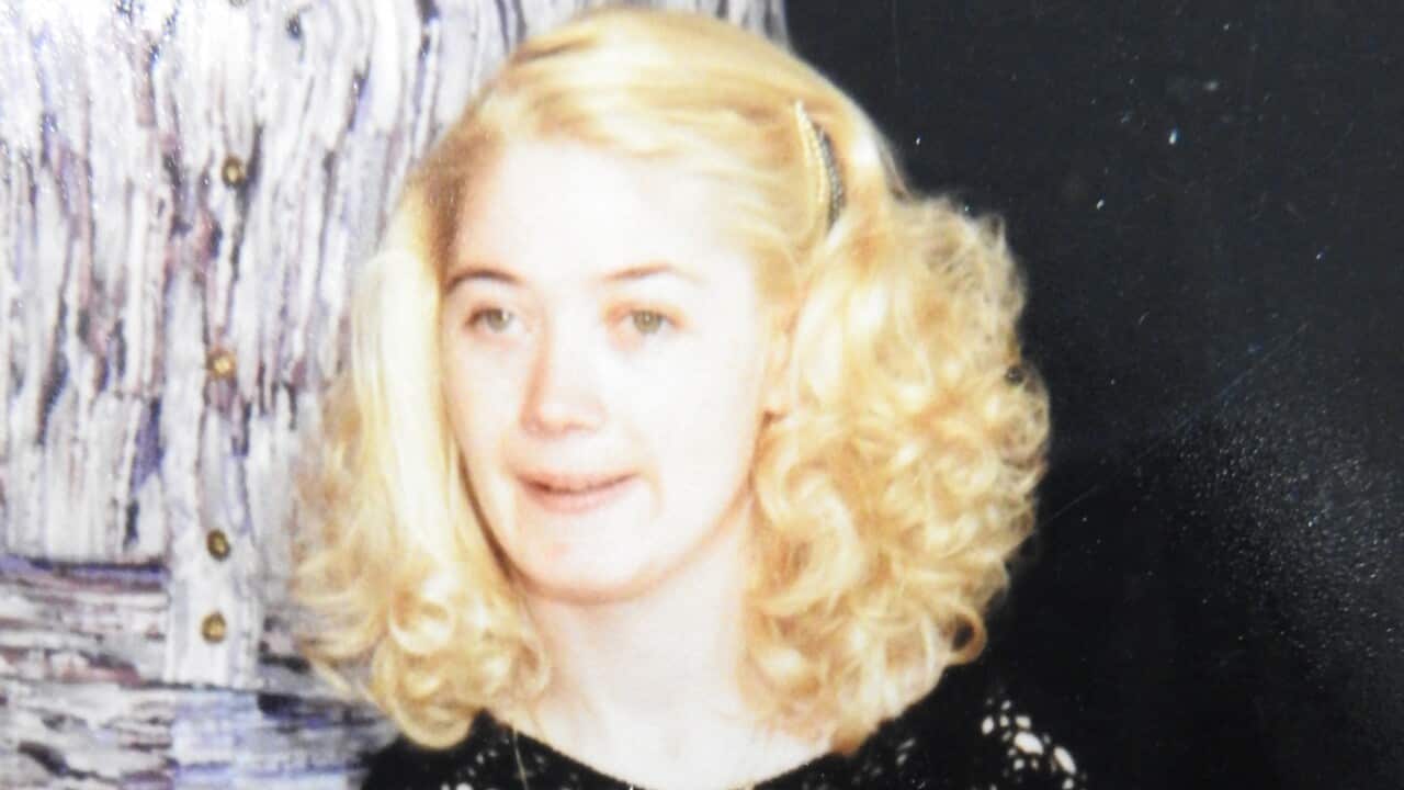 A woman smiles at the camera