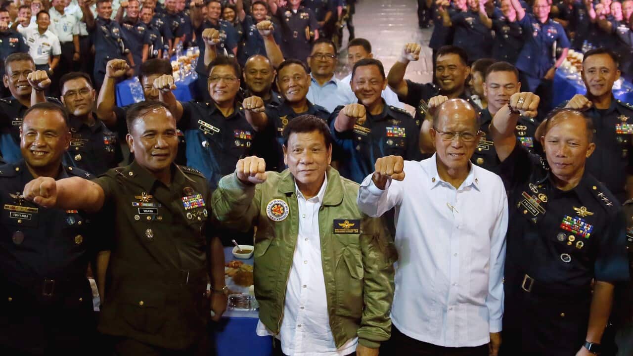 Philippine President Rodrigo Duterte, third from left, gestures with Defense Chief Delfin Lorenzana, second from right.