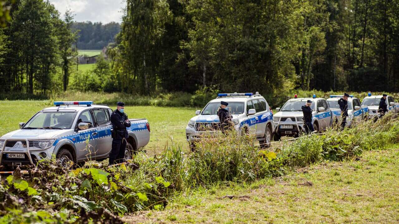 Police officers stand guard at the border.