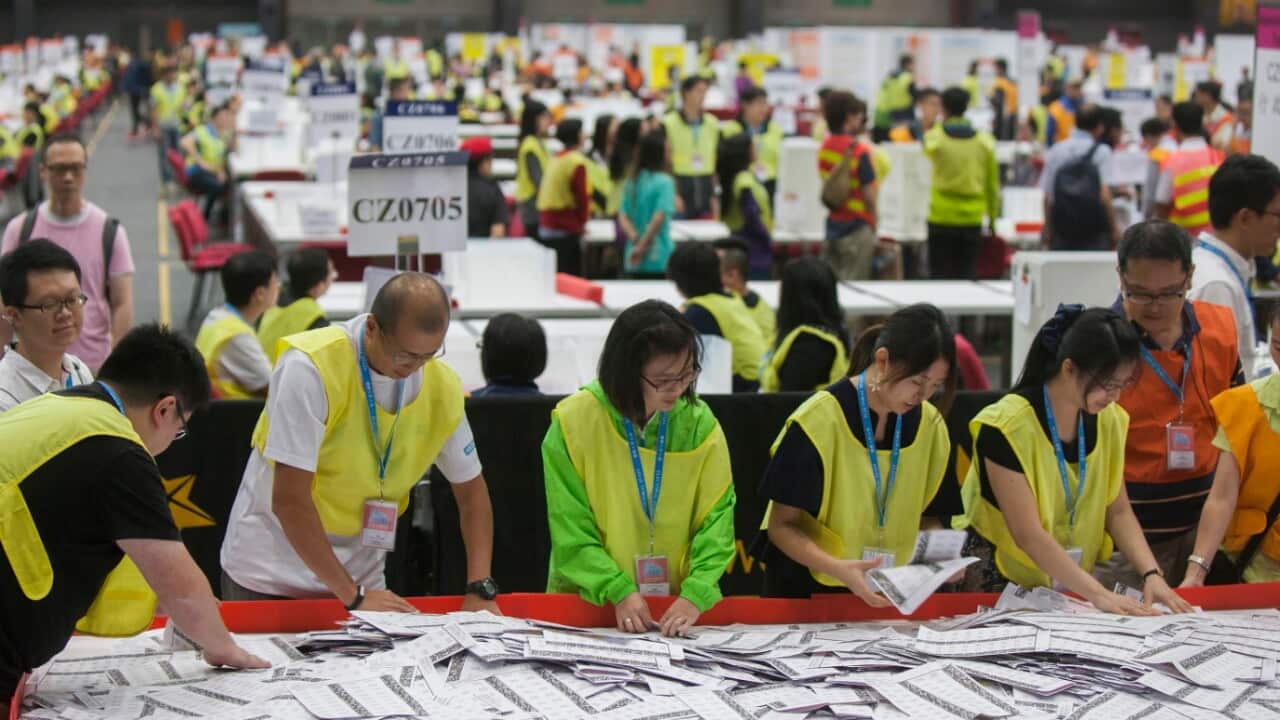 Electoral officers count ballots at the central ballot counting station for the legislative council elections in Hong Kong, Monday, Sept. 5, 2016.