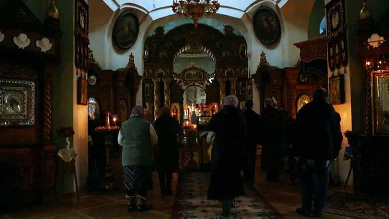 Worshippers at the cathedral in Kherson (Reuters).jpg