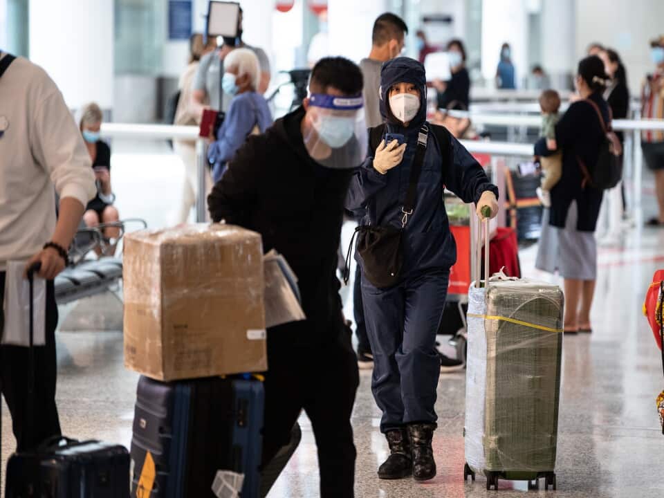 People wearing PPE arriving at Sydney International Airport in Sydney.