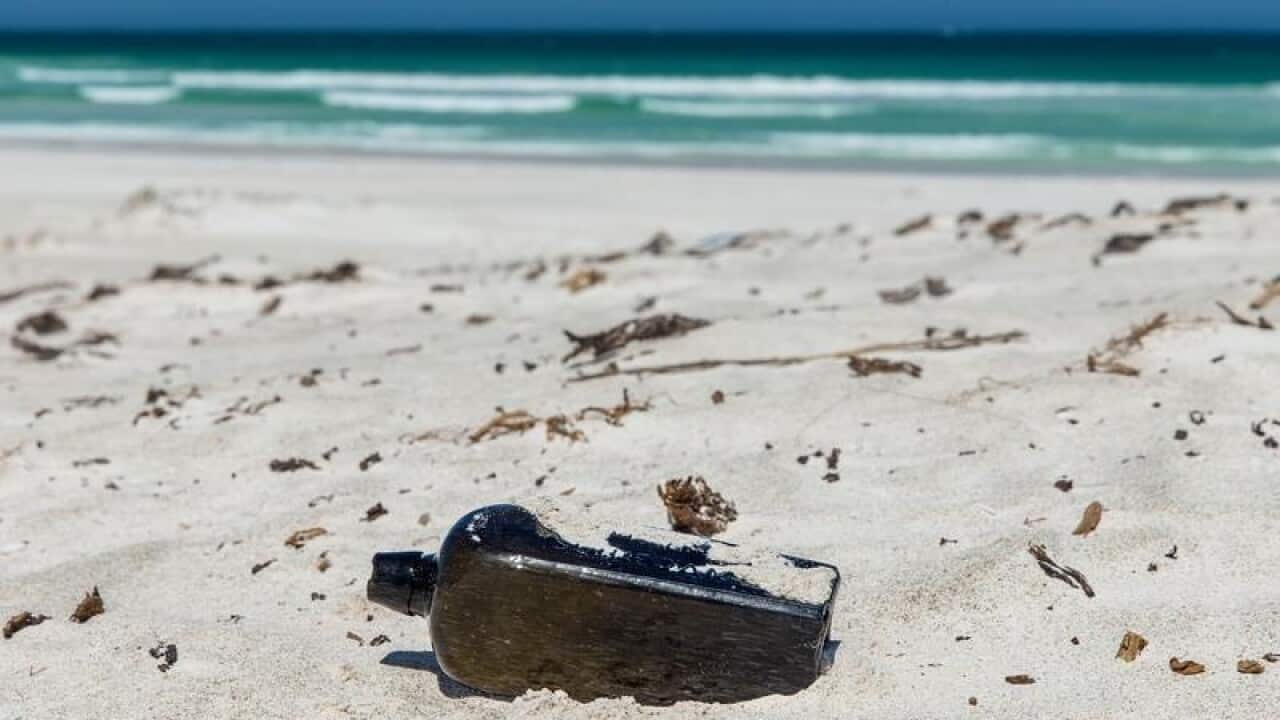 A supplied image of a bottle containing a note on a beach in Perth.