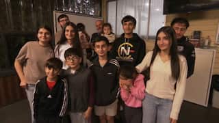 A group of thirteen people and children of different ages.