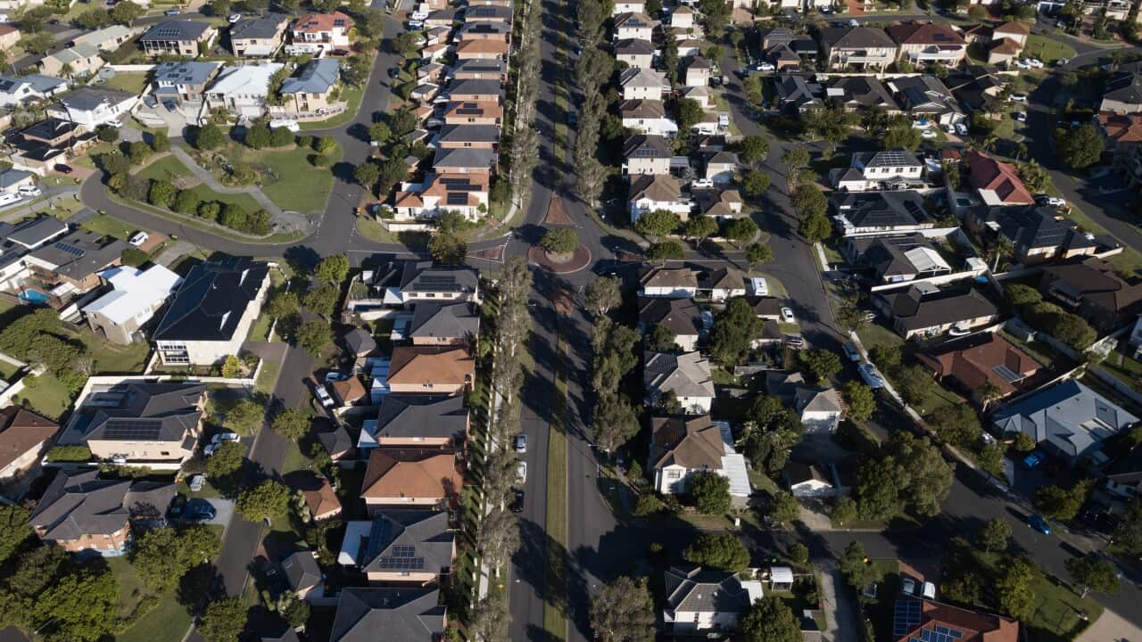 Aerial photo of lines of houses from above.