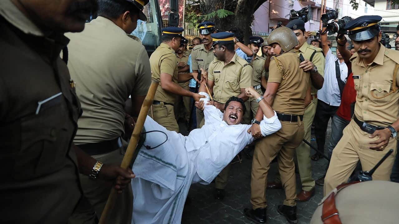 Indian police carry away a protester.