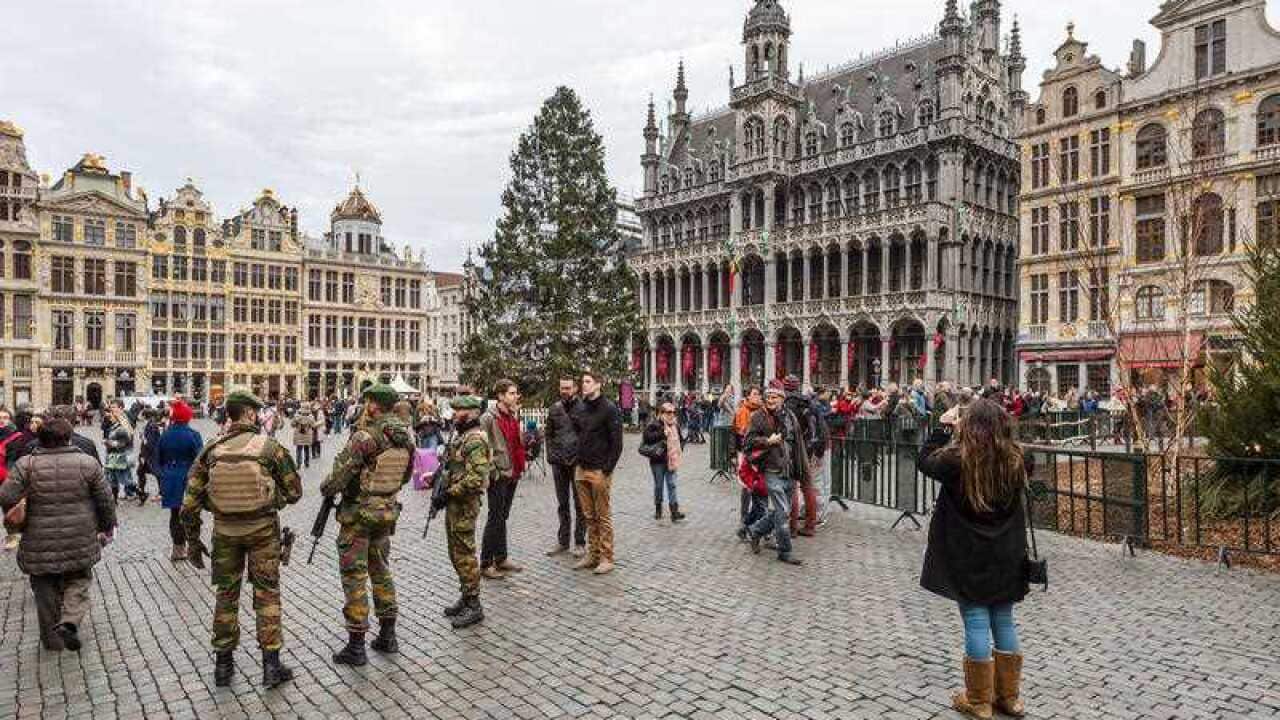 Belgian soldiers patrol as tourists visit the Grand Place in Brussels on Dec. 29, 2015.