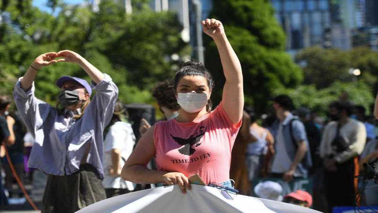 A protester stands outside the Park Hotel in Melbourne.