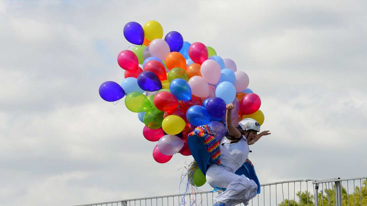 Penny Purdie jumps into the Yarra River during the annual Birdman event as part of the Moomba Festival, Melbourne. (AAP)