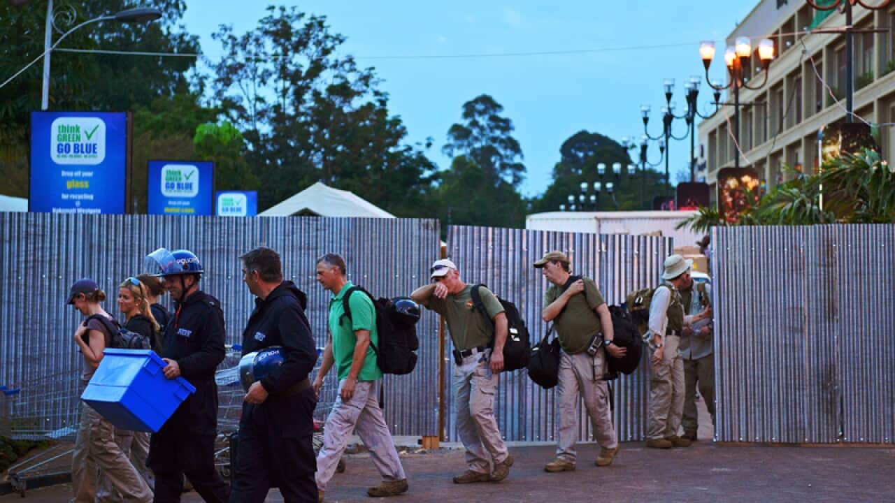 Foreign investigators and police leave the Westgate Mall