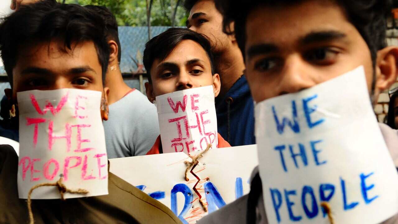 Protesters hold placards during a protest against the Citizenship Amendment Bill in New Delhi, India, on 14 December, 2019.