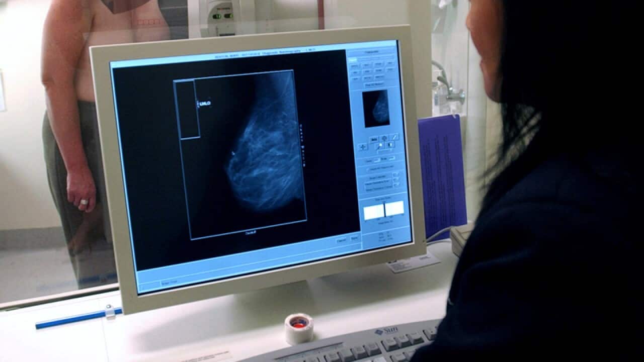 A radiographer performs a mammogram in Melbourne