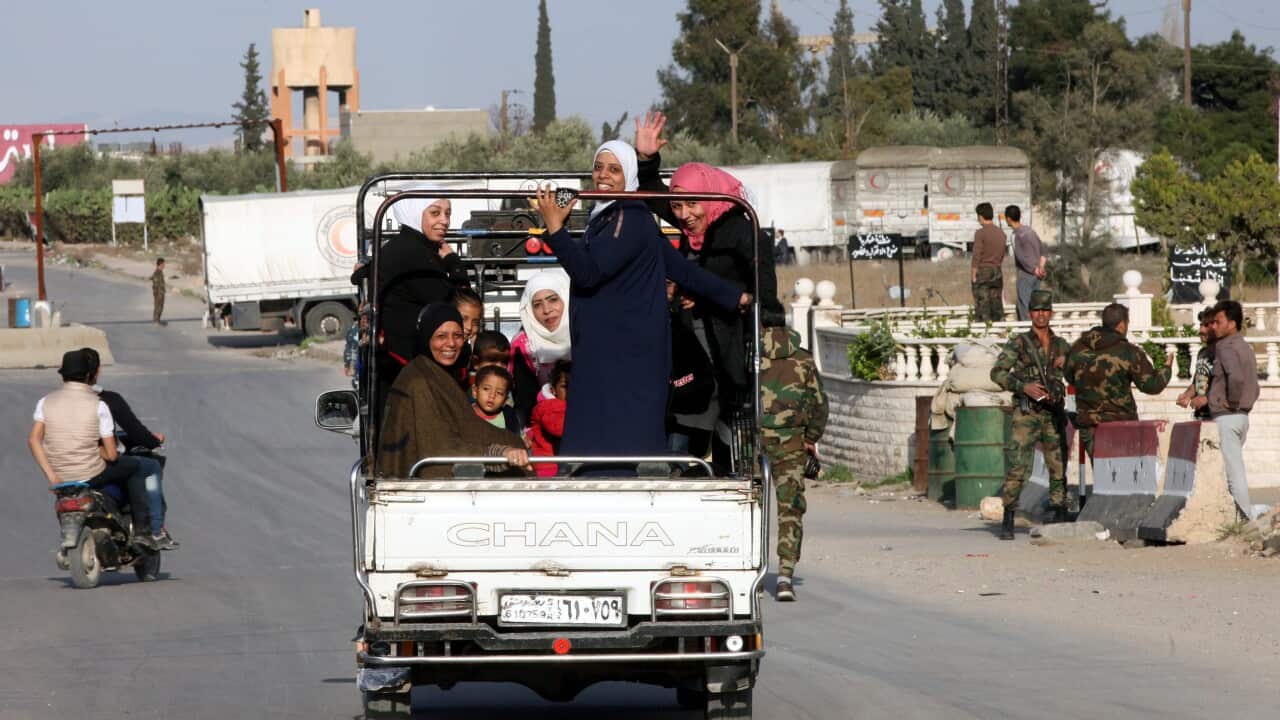 Women wave as a Syrian Arab Red Crescent aid convoy enters al-Wafidin camp in the Damascus countryside, Syria, 04 March 2016.