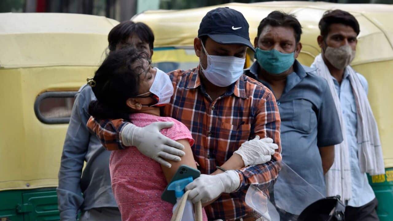 A woman being consoled after the hospital turned away her father from admission into the COVID-19 ward of a hospital in New Delhi, India.