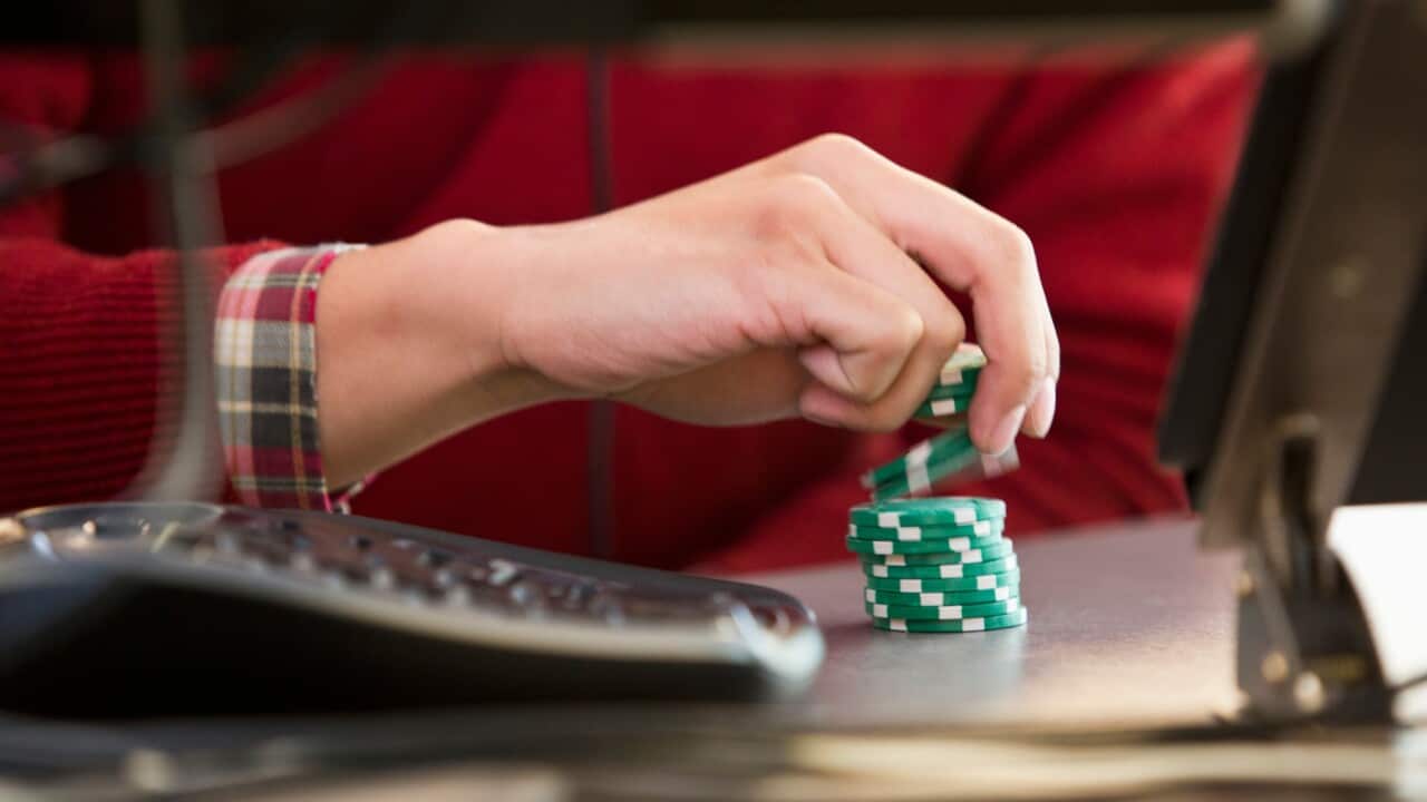 businessman with poker chips at office desk