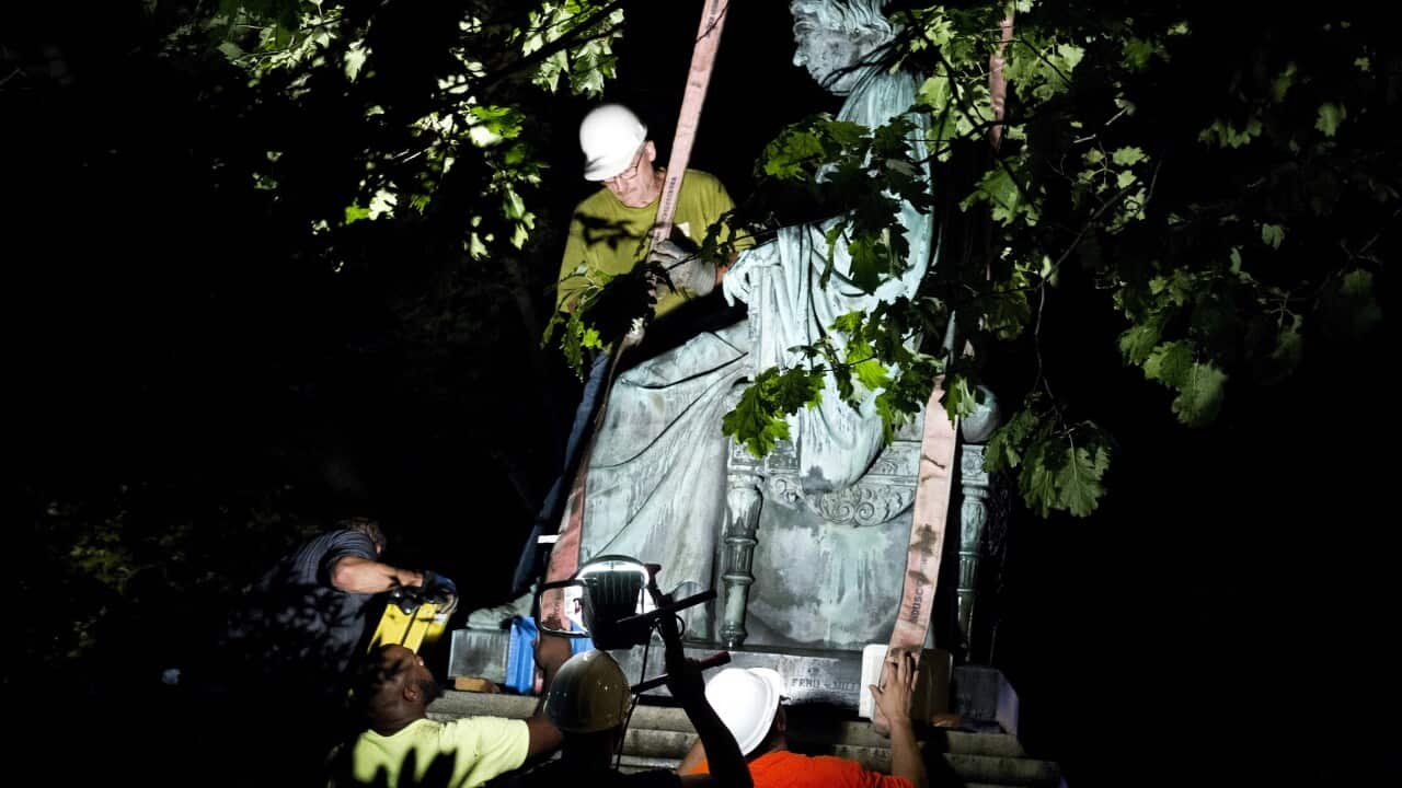 Workers remove a monument dedicated to US Supreme Court Chief Justice Roger Brooke Taney outside Maryland State House in Annapolis.