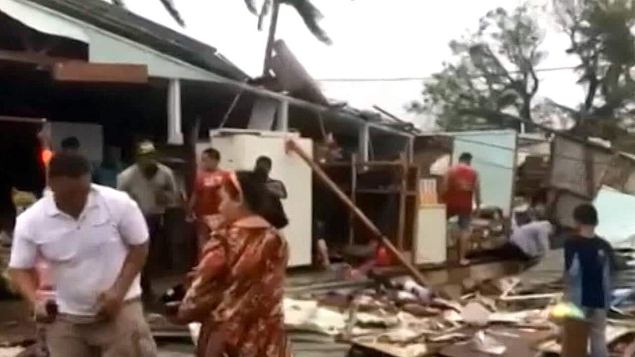 Locals inspect the devastation caused by Cyclone Gita after it swept across the island nation in the middle of the night.