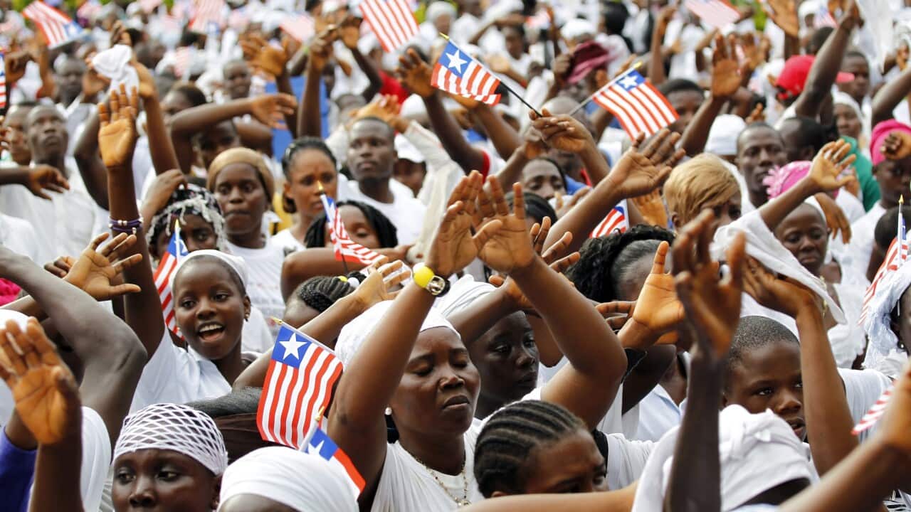 Liberians pray for the end of Ebola during a mass prayer meeting outside Monrovia (AAP)