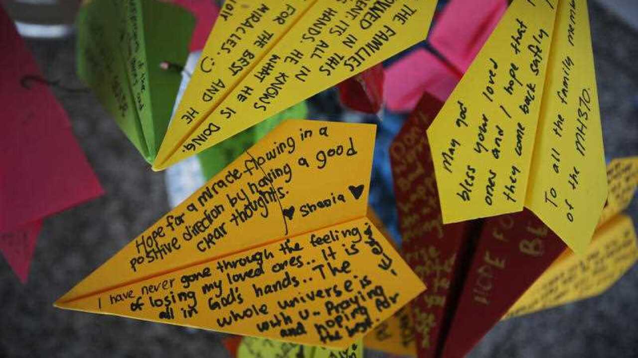 Paper planes with personalized messages dedicated to people involved with the missing Malaysia Airlines jetliner MH370, are placed at the viewing gallery of Kuala Lumpur International Airport, in Sepang, Malaysia (AAP)
