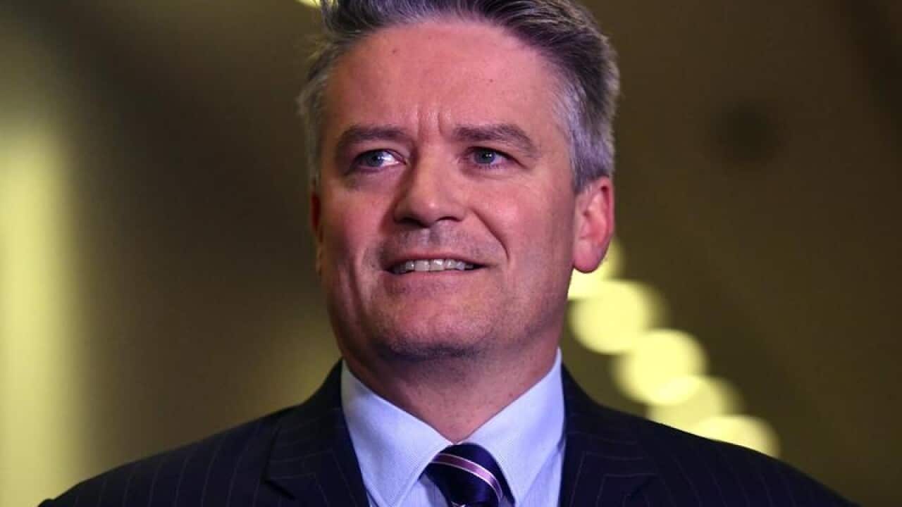 Senator Mathias Cormann smiles.
