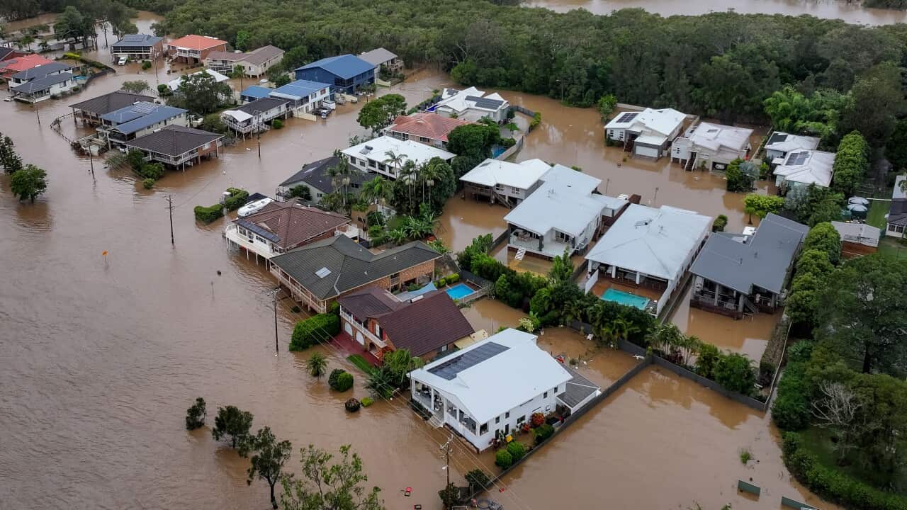 Aerial view of brown floodwaters and houses