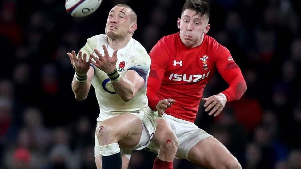 England's Mike Brown jostles with Josh Adams.