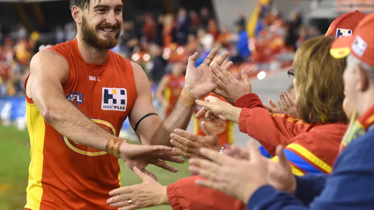 Suns player Charlie Dixon celebrates with fans