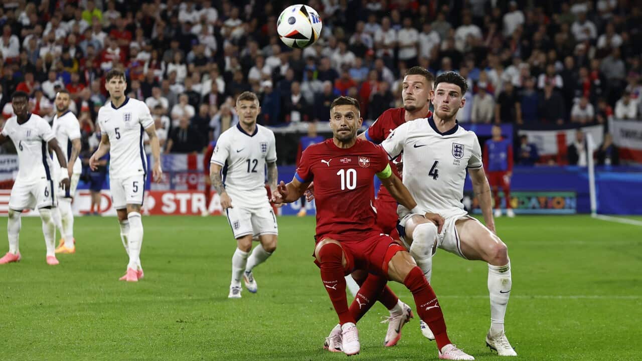 Serbia's player Dusan Tadic vies for the ball with England player Declan Rice, with Serbia's Sergej Milinkovic Savic in the background