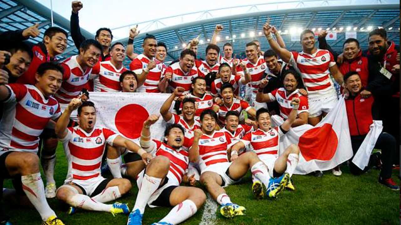 Japan celebrates after defeating South Africa