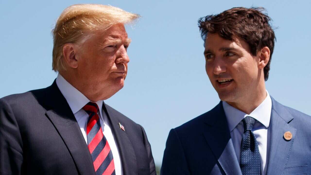 President Donald Trump talks with Canadian Prime Minister Justin Trudeau during a G-7 Summit welcome ceremony, Friday, June 8, 2018, in Charlevoix, Canada. 