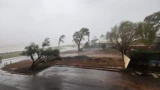 Strong winds and heavy rain from tropical Cyclone Narelle lash a coastal town.