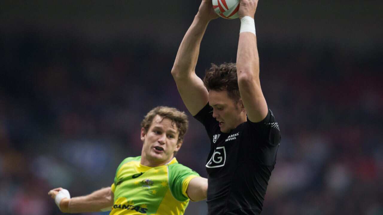 NZ's Lewis Ormond (R) grabs the ball ahead of Australia's Con Foley