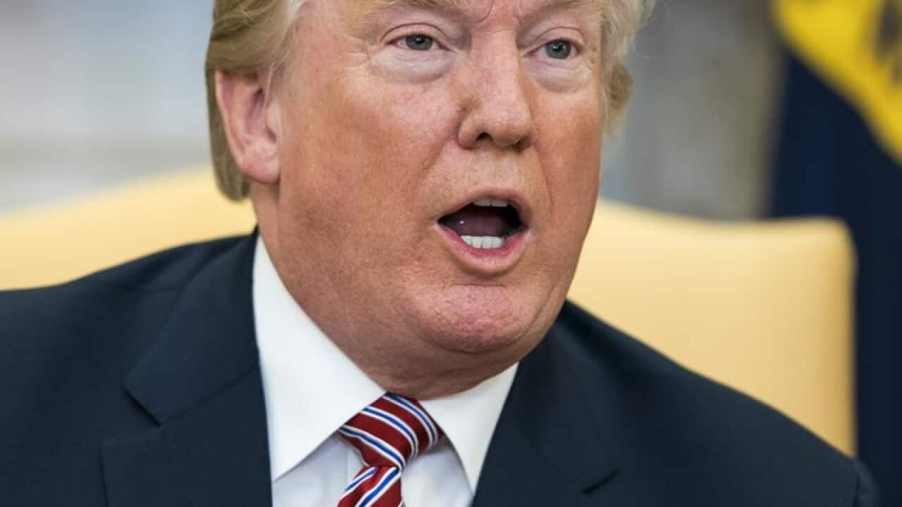US President Donald Trump speaks to the Oval Office in Washington.