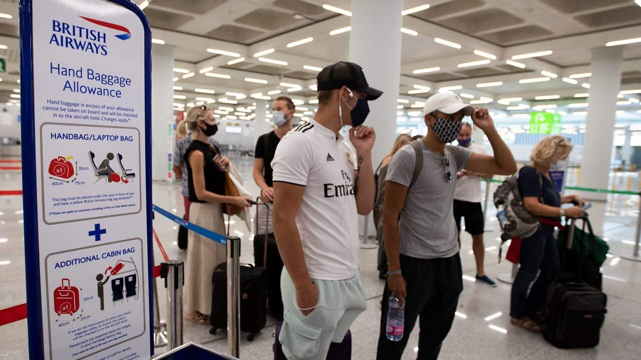British tourists wait to check in for a flight to London at the airport in Palma de Mallorca on July 27, 2020.