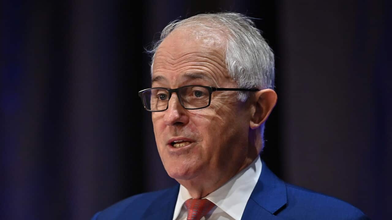 A man speaking on a podium