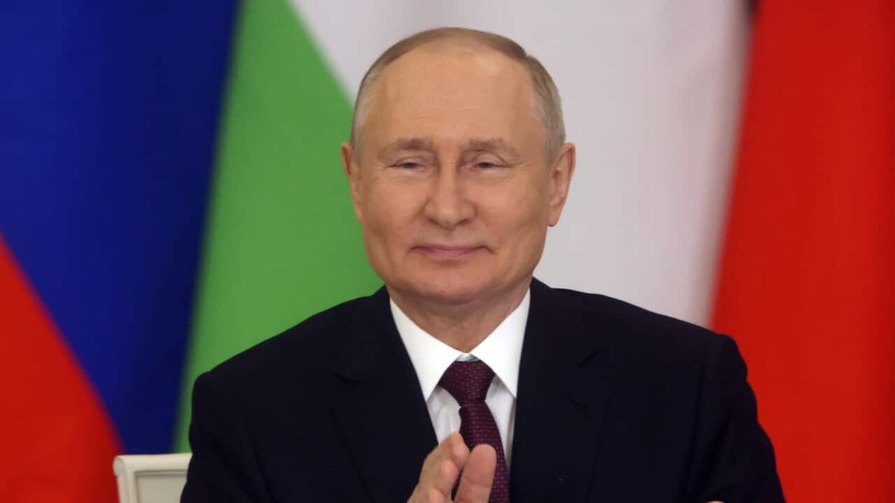 Russian president Vladimir Putin is clapping his hands