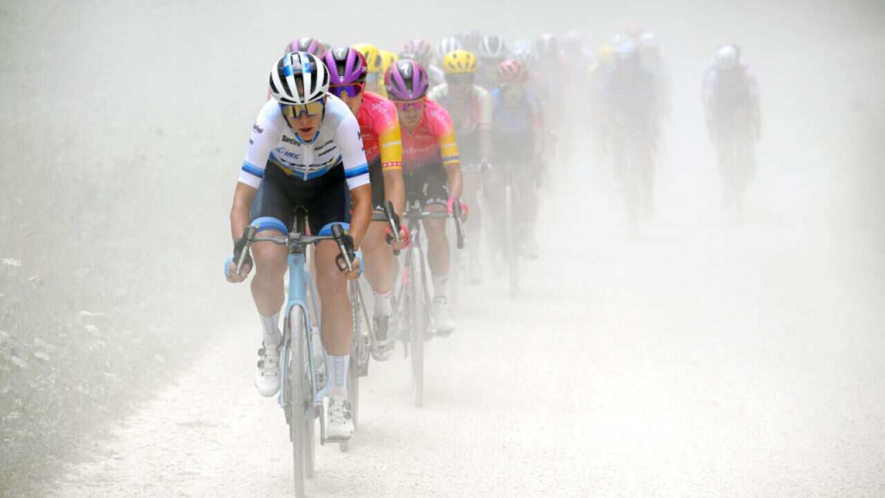 Ellen Van Dijk and Marlen Reusser lead the peloton through a gravel road sector during the 1st Tour de France Femmes 2022, Stage 4