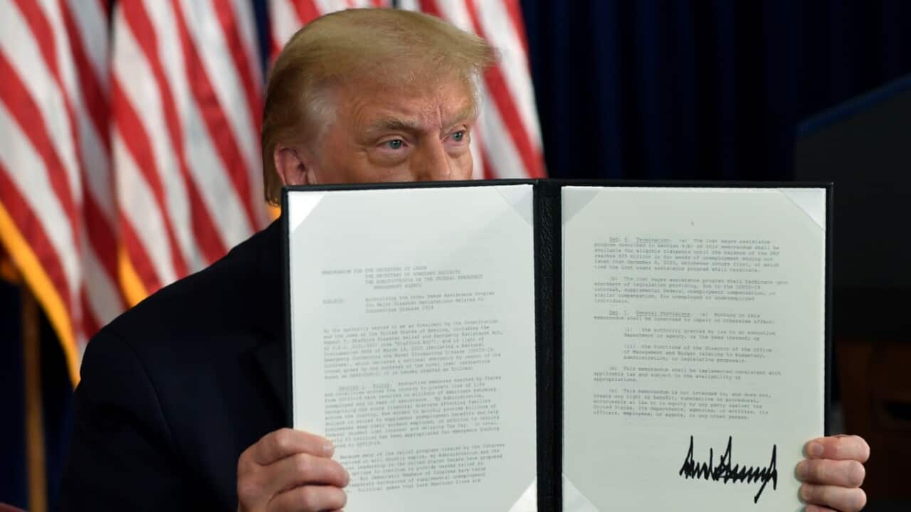 President Donald Trump signs an executive order during a news conference at the Trump National Golf Club in Bedminster, NJ Saturday, Aug. 8, 2020.
