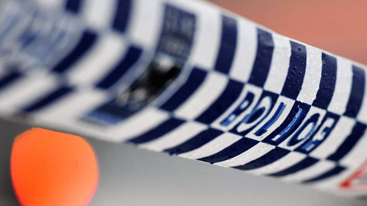 Police tape restricts access to a crime scene
