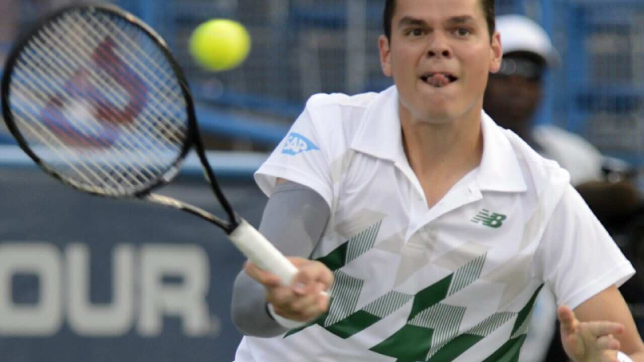 Milos Raonic returns the ball.