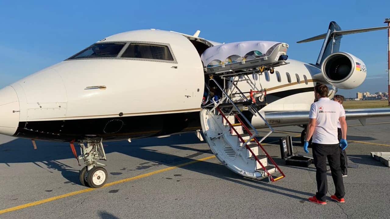 Medics upload Alexei Navalny into a German special medical plane at the airport in Omsk, Russia.