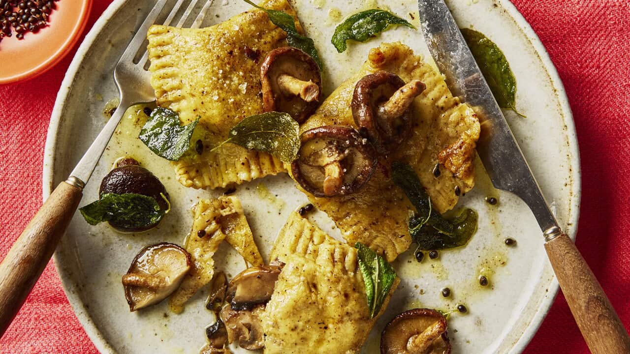 Three large ravioli and some scattered mushrooms.