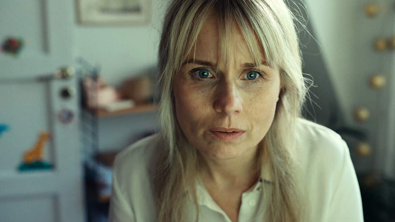 A middle-aged woman stares blankly as though disappointed.jpg