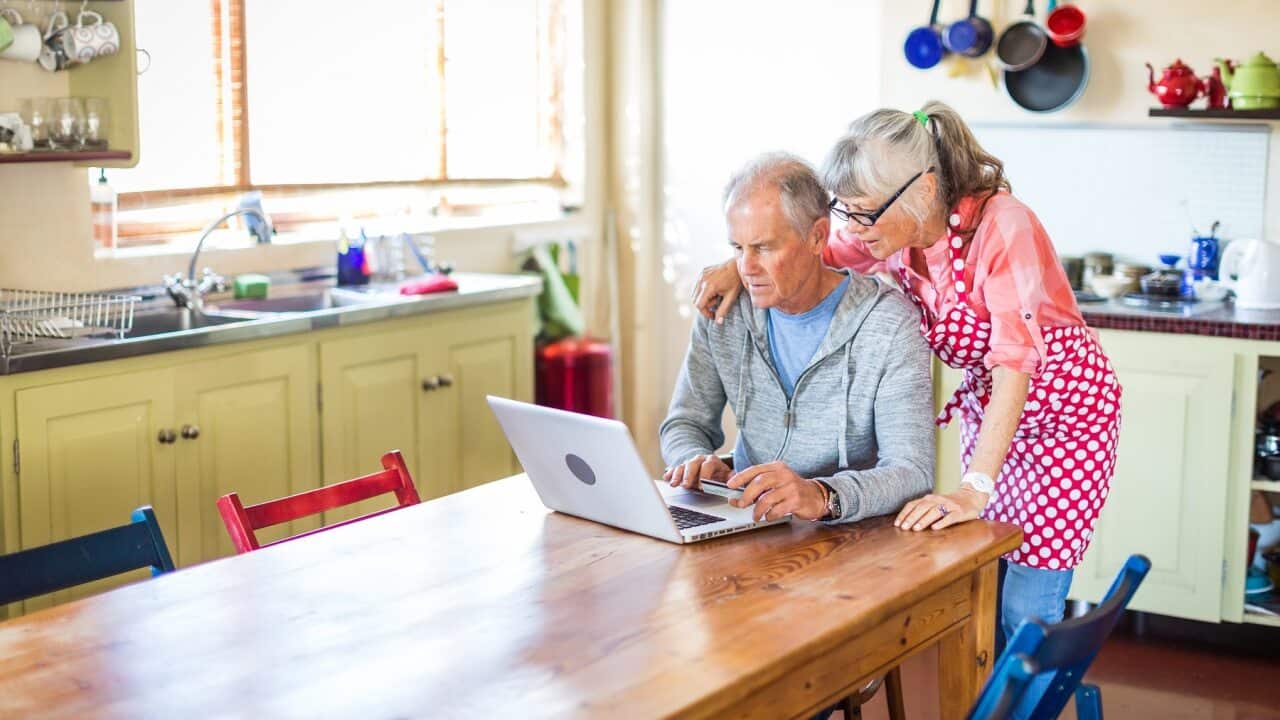 An older couple tackling online banking