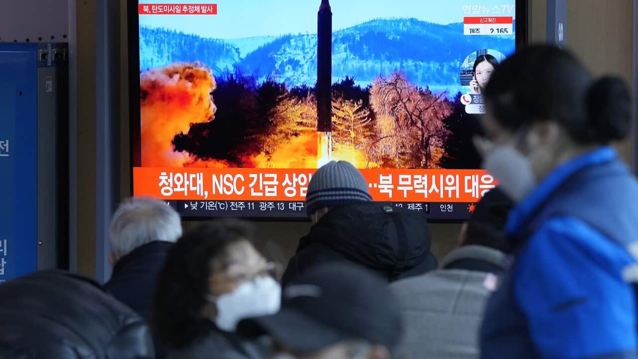 People watch a TV showing a file image of North Korea's missile launch during a news program at the Seoul Railway Station in Seoul, South Korea.