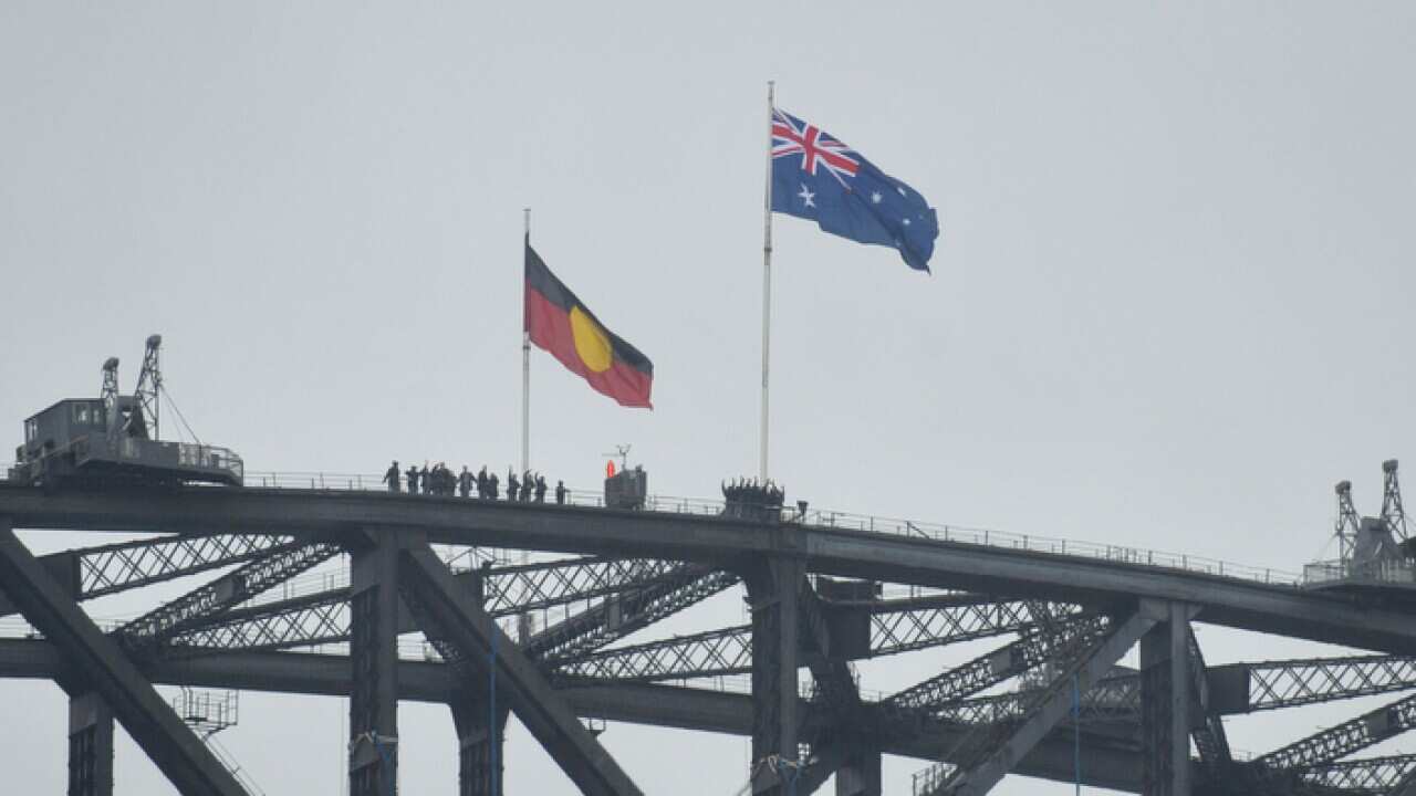 Australian and Aboriginal flags seen on the Harbour Bridge as part of Australia Day celebrations in Sydney, Monday,Jan. 26, 2015