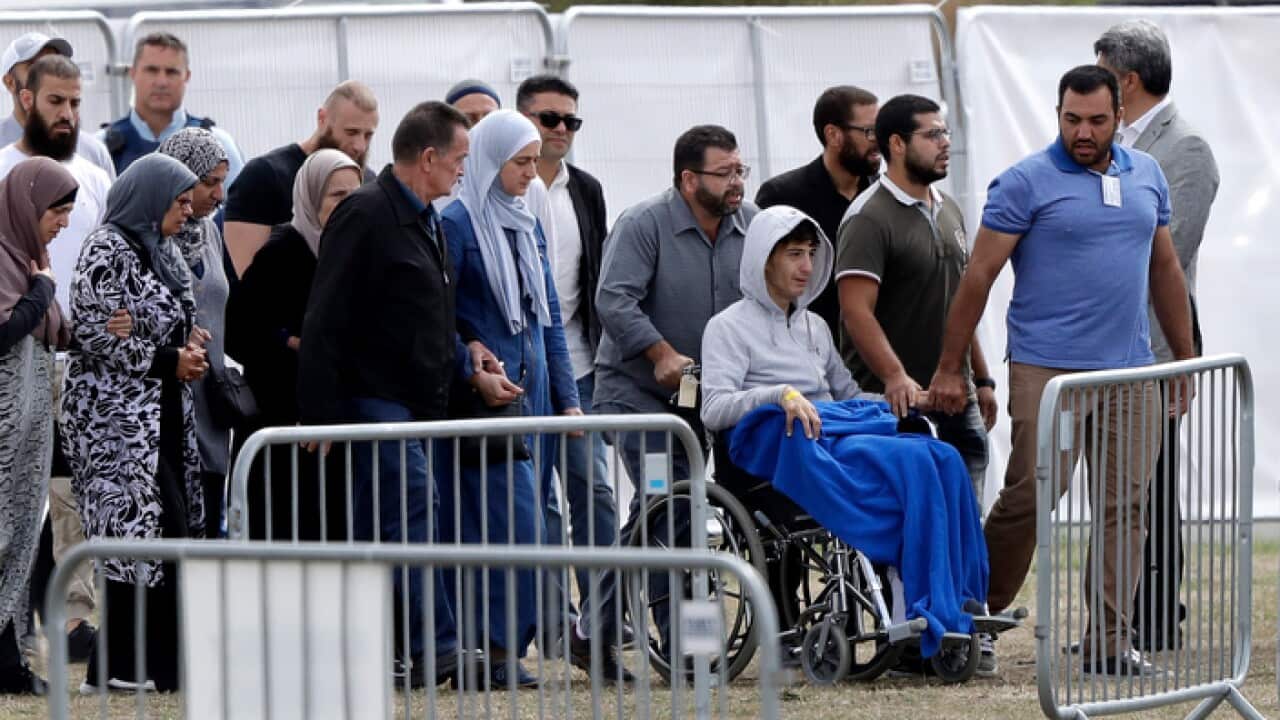 Zaed Mustafa, in wheelchair, brother of Hamza and son of Khalid Mustafa killed in the Friday March 15 mosque shootings arrives for the burial at the Memorial Park Cemetery in Christchurch, New Zealand, Wednesday, March 20, 2019. (AP Photo/Mark Baker)
