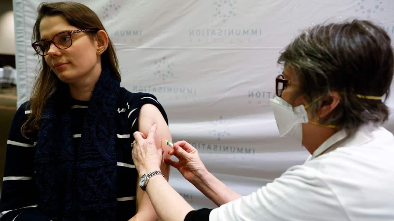 A woman receives a free flu vaccination at the Melbourne Town Hall in Melbourne