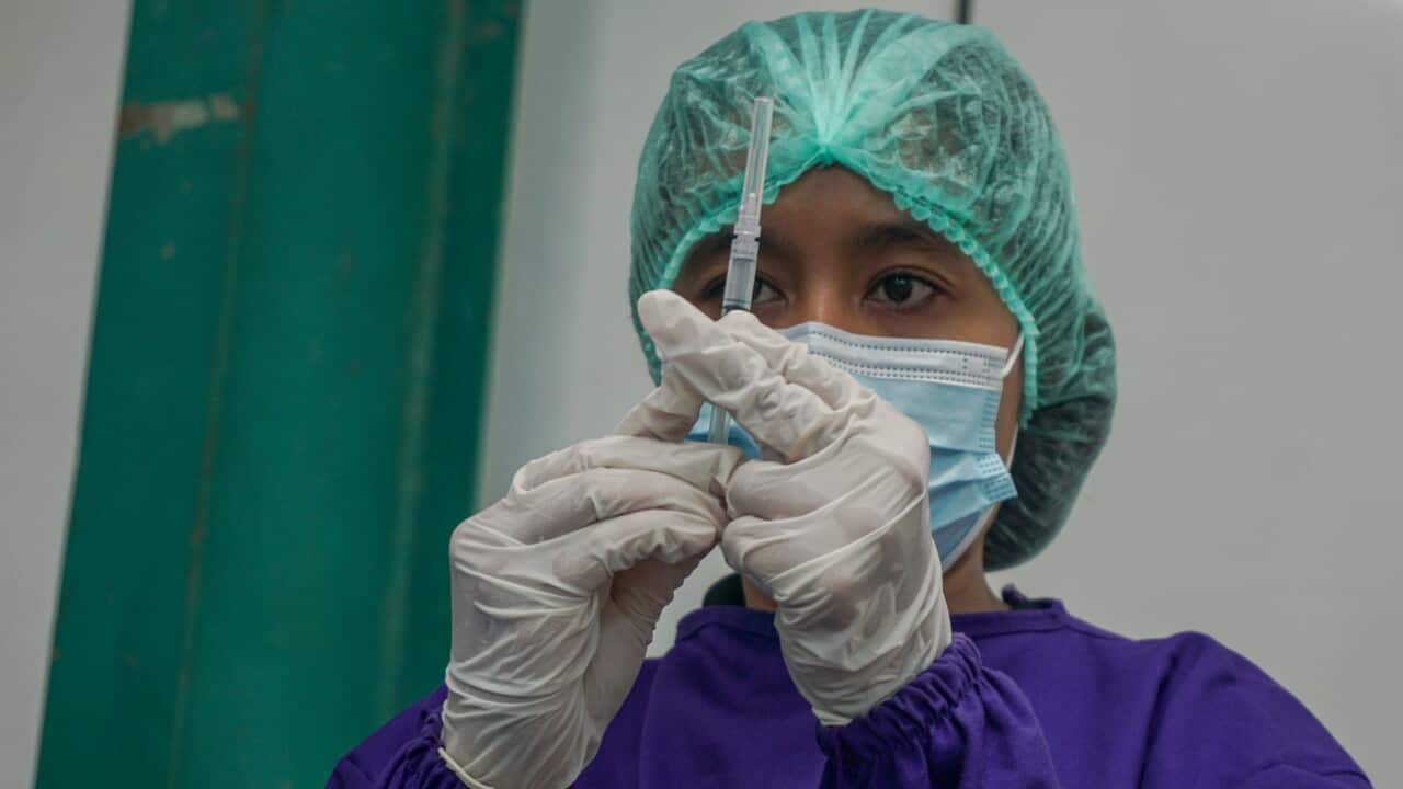 A health worker prepares an AstraZeneca vaccine during a mass vaccination in Bali, Indonesia.